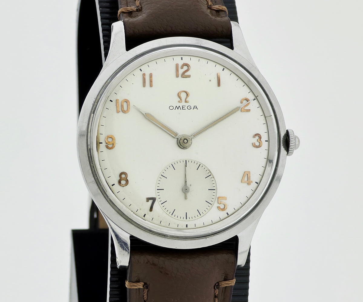vintage Omega wristwatch 2403/1 with a silver-toned metal case, white dial, tan Arabic numerals, and a brown leather strap, shown against a light gray background.